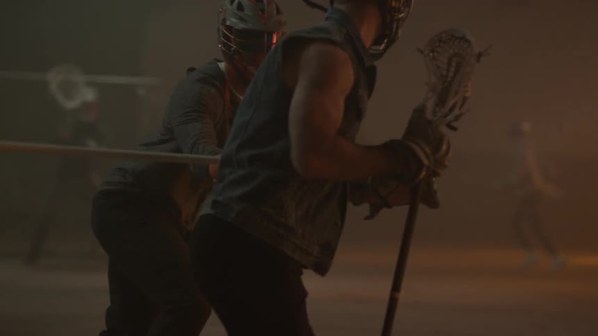 Two lacrosse players face off