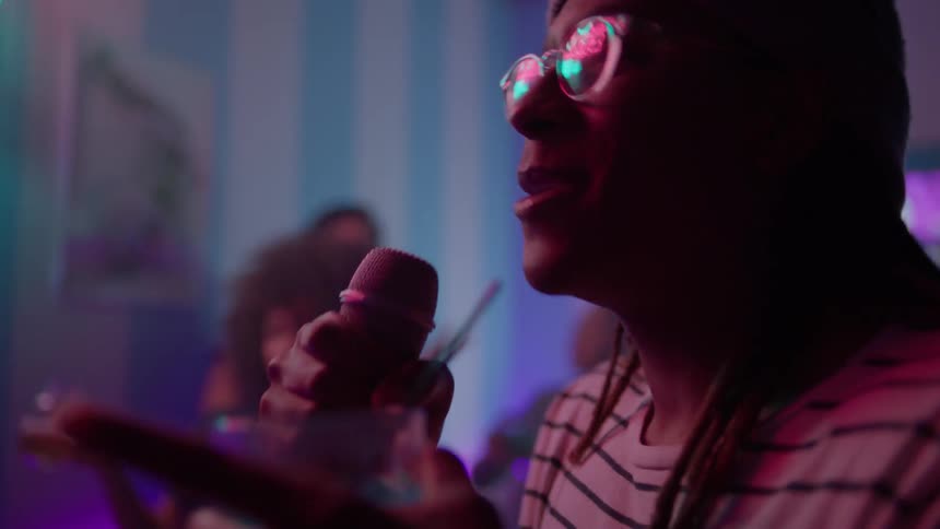 A man performs karaoke at a bar