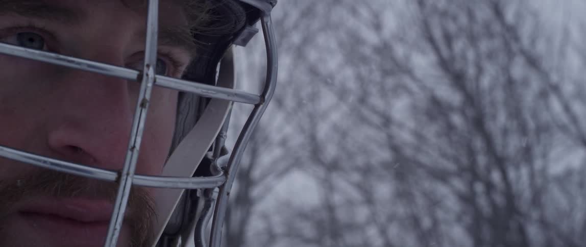 A man looks up as it snows