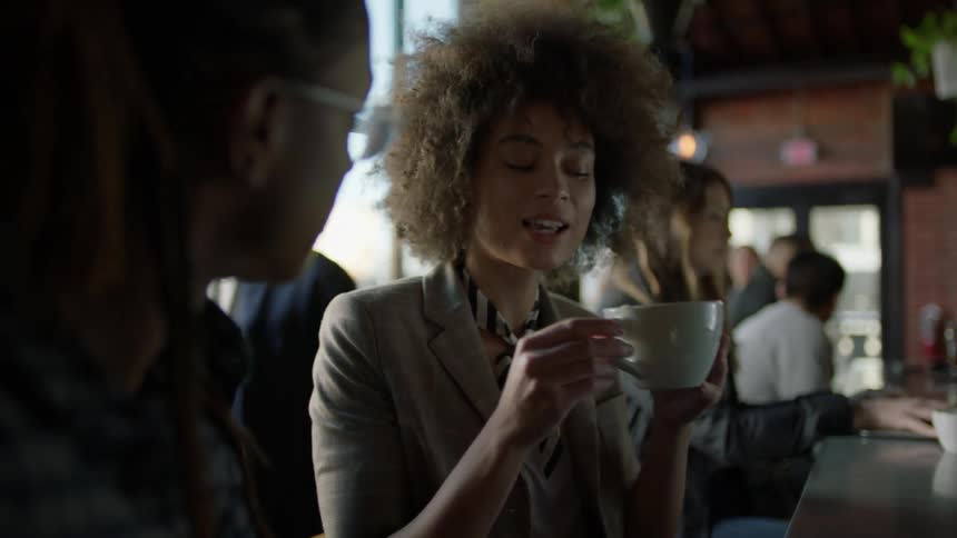 Woman sipping coffee from a large mug