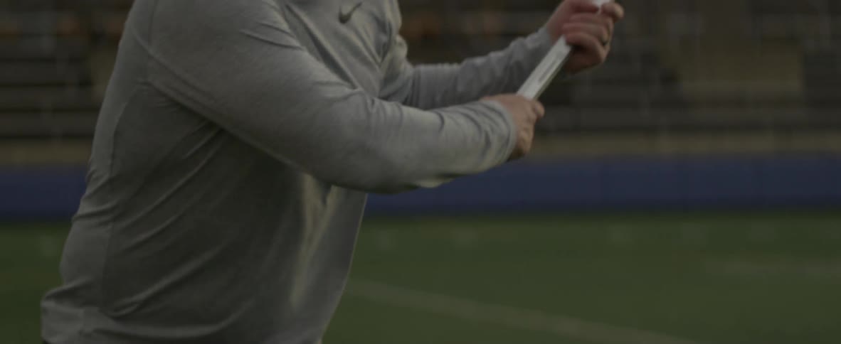 A man throws a lacrosse ball with a stick