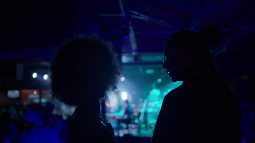 A man and woman dance in a club