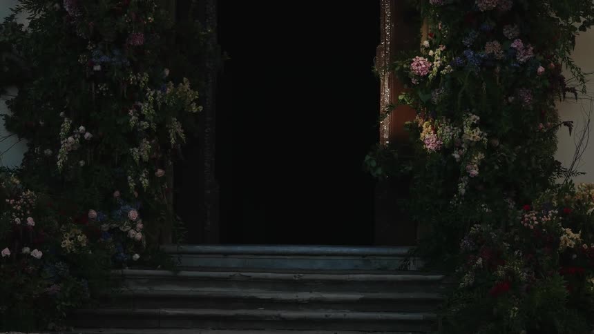 The door is surrounded by flowers and vines