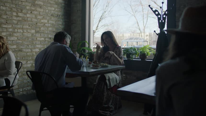 A man and woman dine in a restaurant