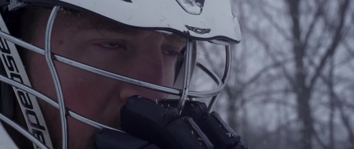 A man is wearing a helmet outside in the snow