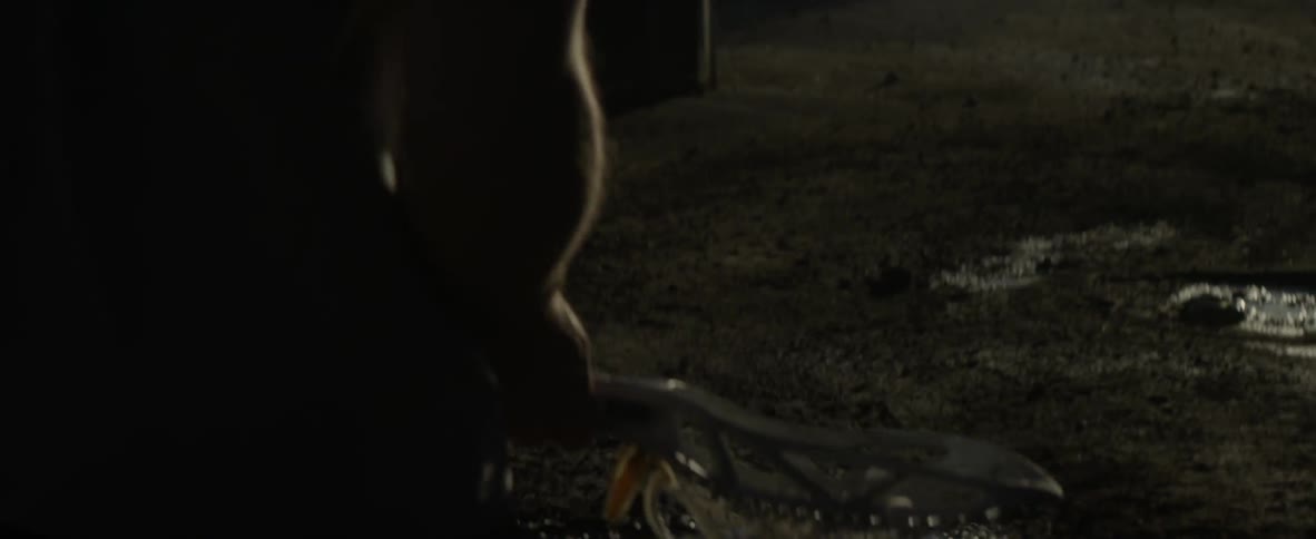 A man tosses a ball and catches it with a lacrosse stick