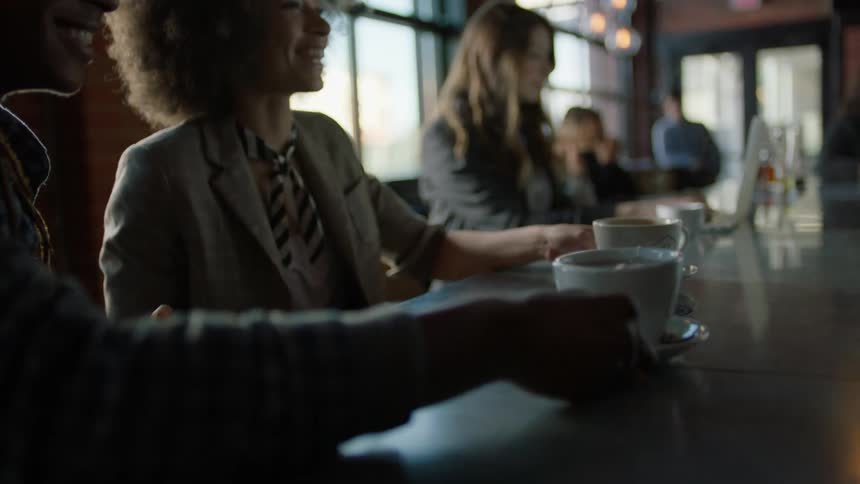 A man and woman get coffee in a coffee house