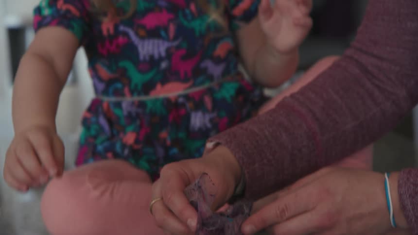 A mother and child dye eggs together