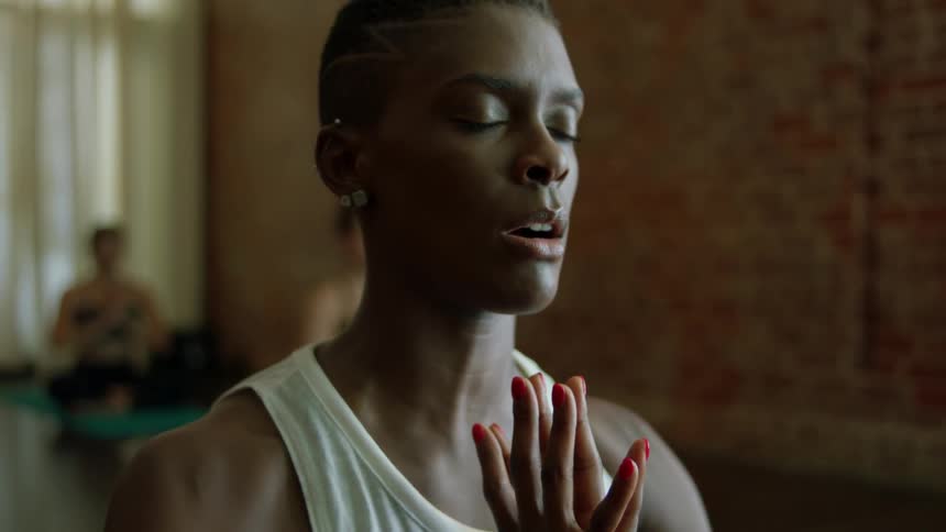 A group of women meditate and do yoga
