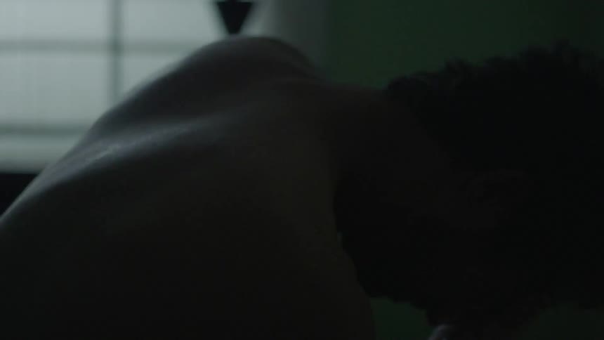 A man holds his face then sits up