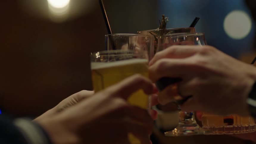 A group of people toast in a bar