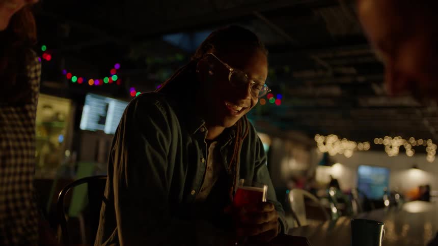 Customers chat with a bartender
