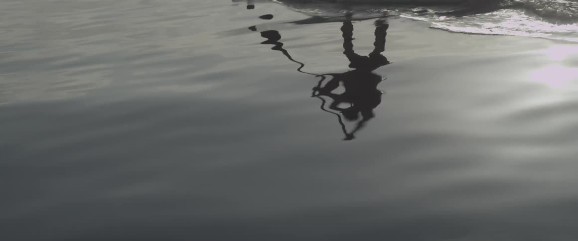 A man paddles on a board in the ocean