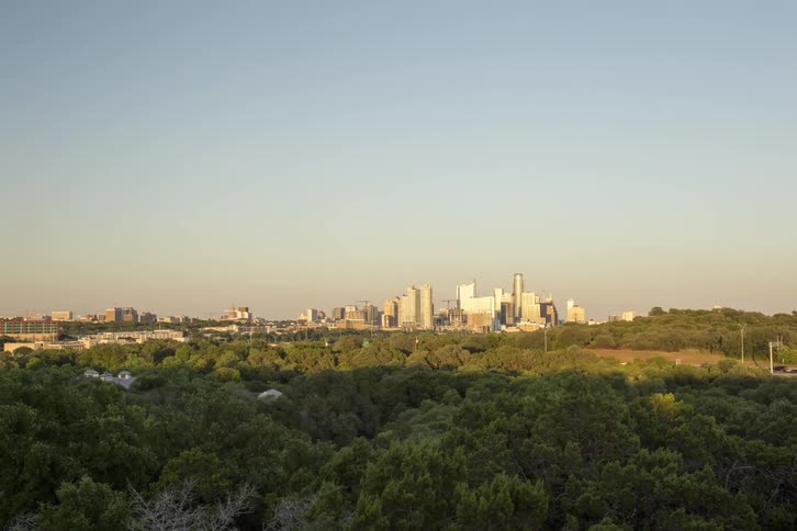 A cityscape is shown at sunset
