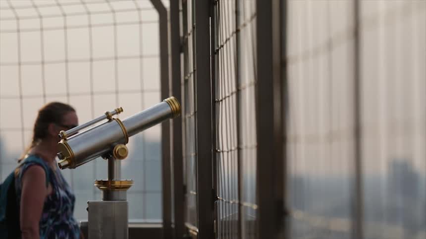 People walk at a lookout with periscopes