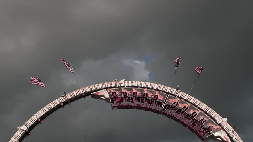 Flags line the top of the roller coaster loop ahead