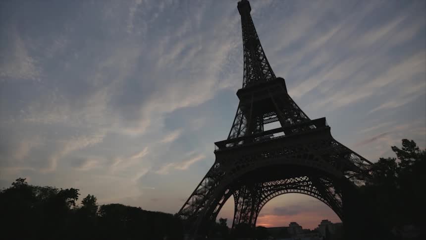 People sit underneath the eiffel tower
