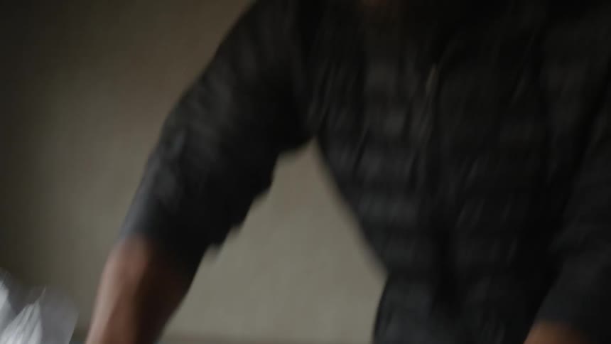 A man chops onions in the kitchen