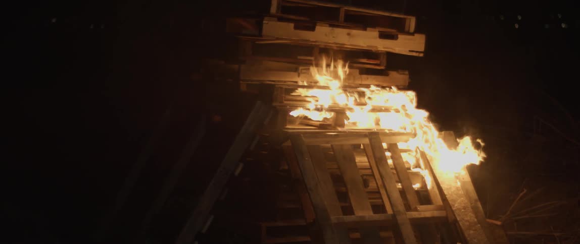 A pile of pallets if burning at night