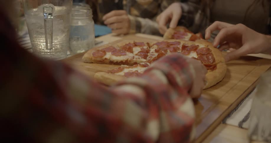 A group of people eating pizza