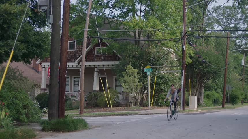 A woman rides a bicycle on the street