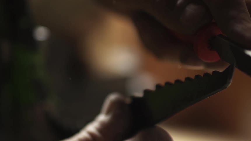 A man is sharpening a tool