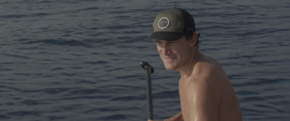 A man paddles in the ocean
