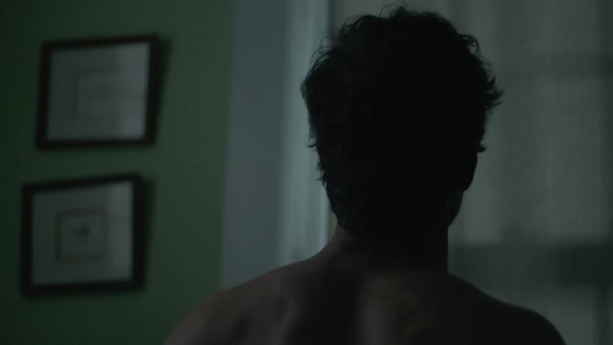 A man is stretching by his window