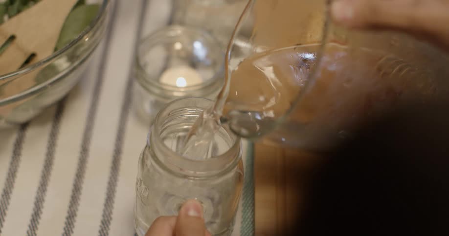 Water is poured from a pitcher into a mug