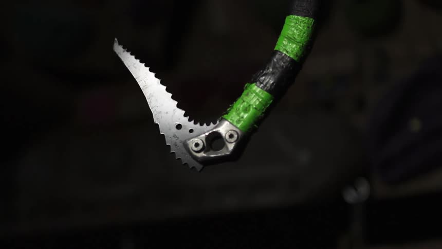 A rock climbing tool is hanging twirling in a circle
