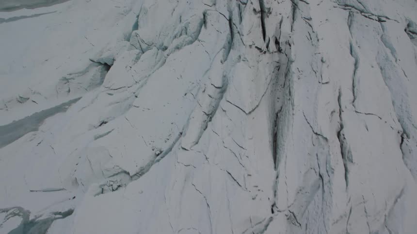 Overhead view of cracks and crevasses in a glacial ice field