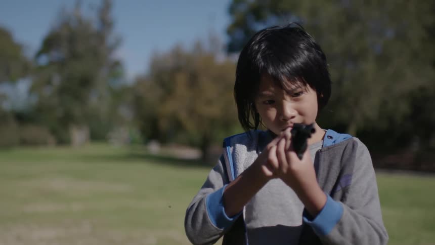 A child is pointing a gun forward