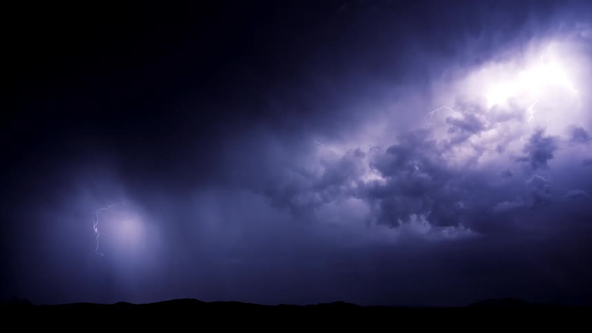 Lighting erupts and flashes as the storm intensifies in the night sky