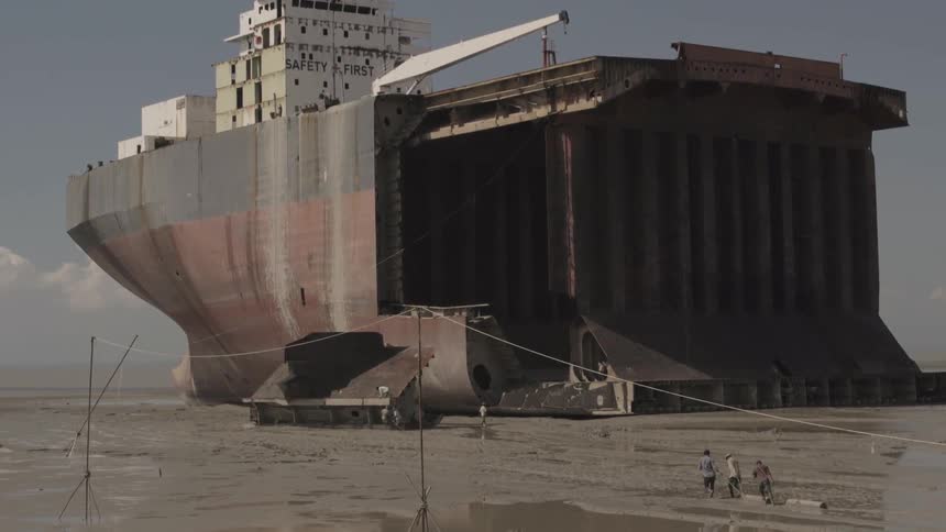 Part of a very large ship in the middle of flat land