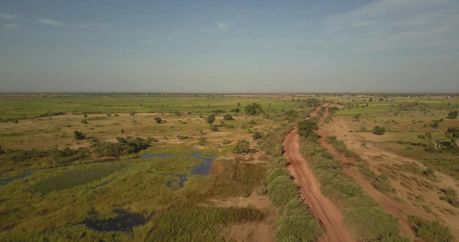A dirt road through a plains