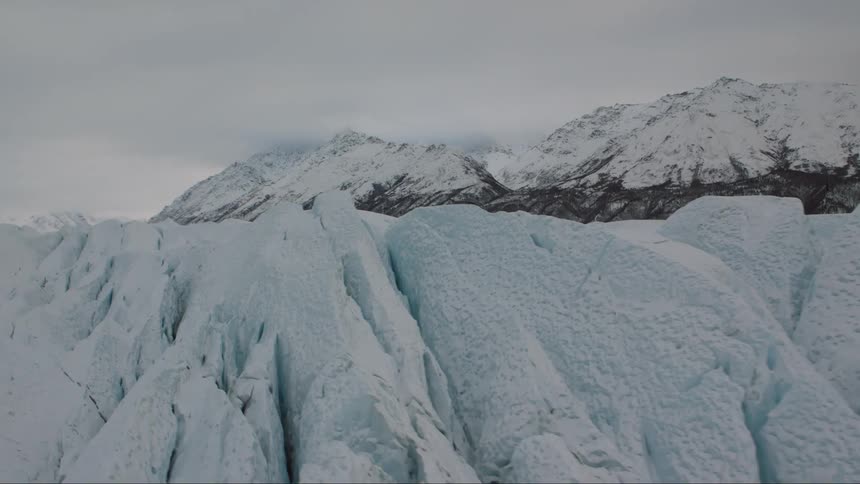 Skimming along the crevasses and craggily edge of blue glacial ice
