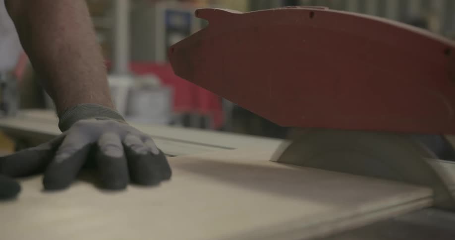 A man saws a plank of wood