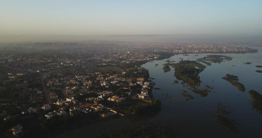 A city by a river is being filmed from the air
