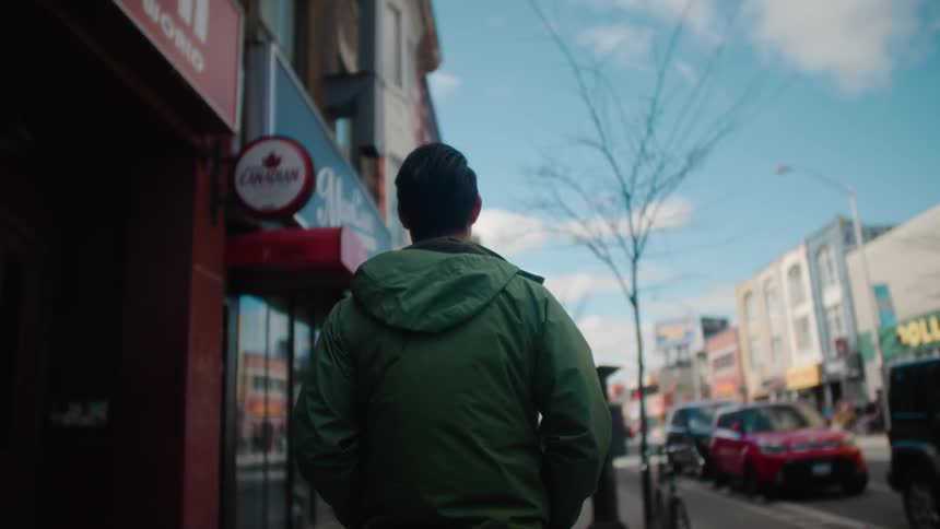 A man is walking down the town street