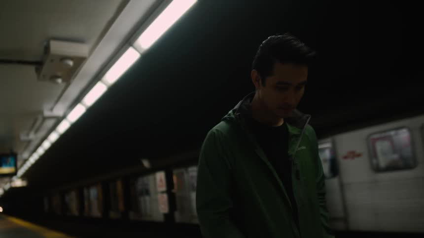 A man stands in a subway