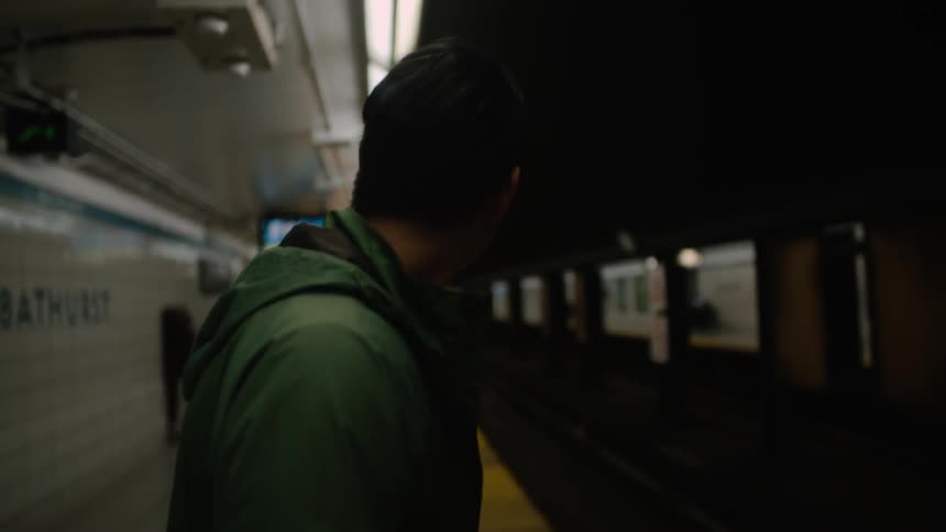 Man waits on a train platform