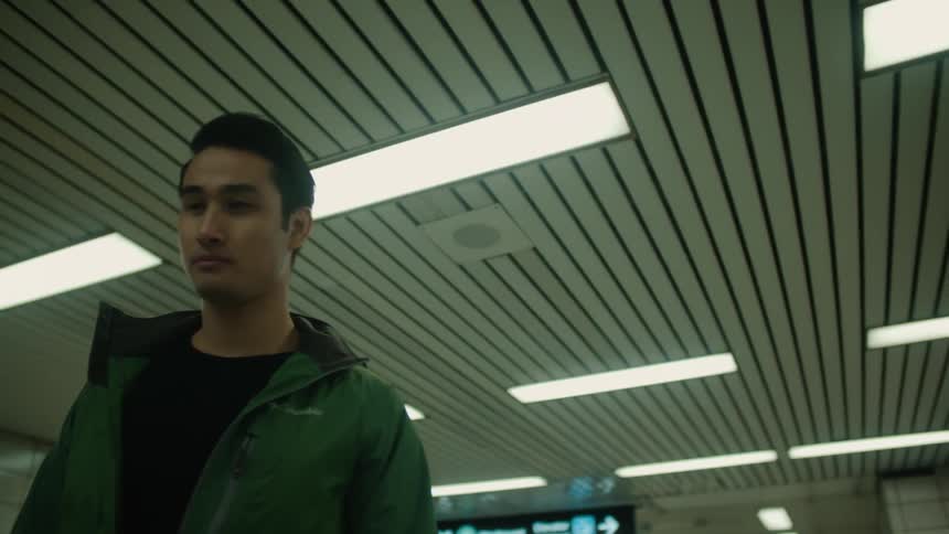 A man is walking in a transit center