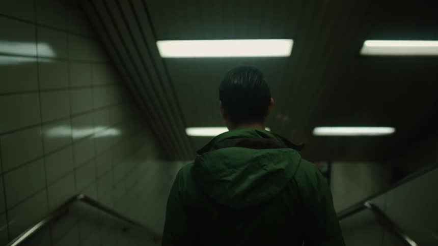 Man walking down stairs into subway