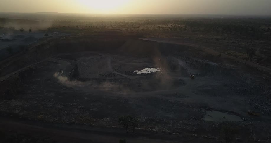 A truck churns up dust while driving on a dirt road