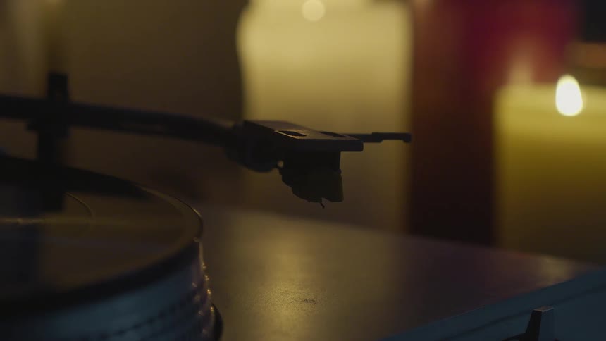 A person adjusts the record player
