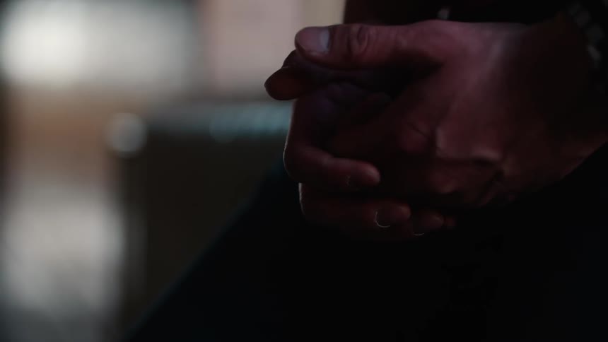 A person clasps and unclasps their hands