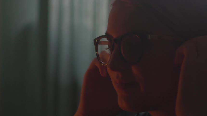A woman puts on headphones
