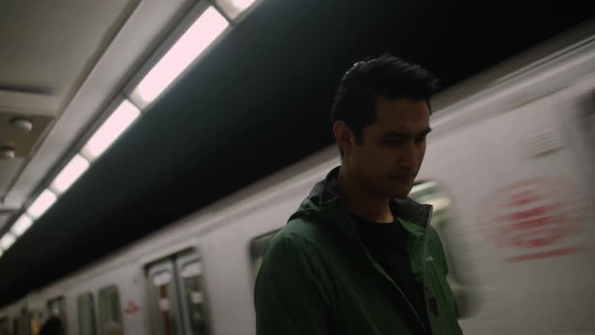A man waits on a subway platform