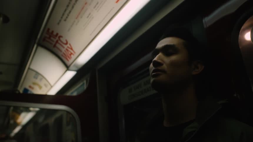 A man is standing in a moving train