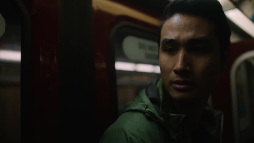 A man is waiting on a train for his stop to come up